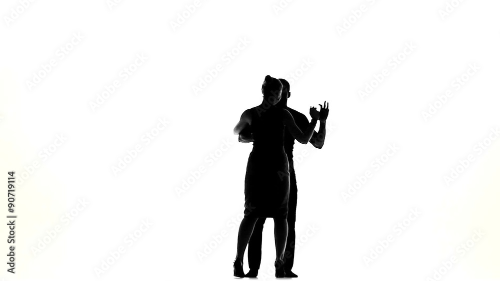 Latino dancers in action, silhouette, on white, slow motion Latino dancers in action, silhouette, on white, slow motion