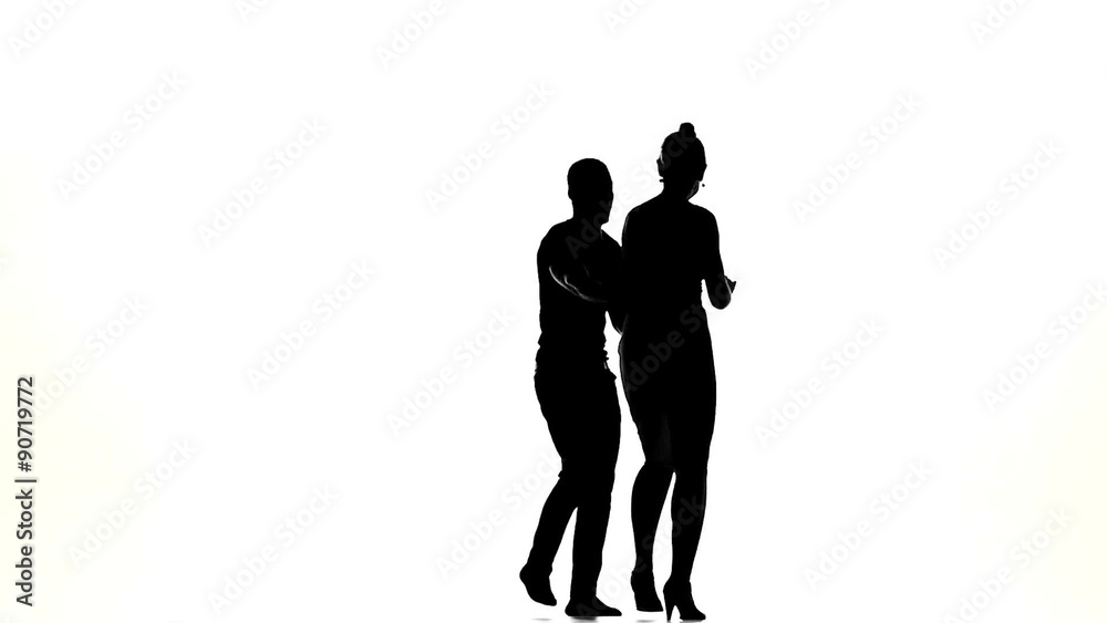 Couple of social latino dancers in action on white, slow motion Couple of social latino dancers in action on white, slow motion