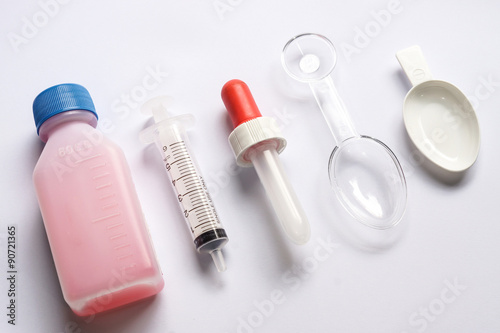 Different tools used for feeding liquid medicine to young baby
