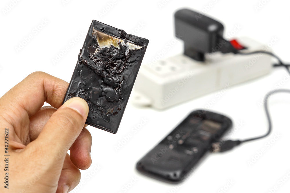 mobile phone battery explodes and burns due to overheat / danger of using smart phone StockFoto