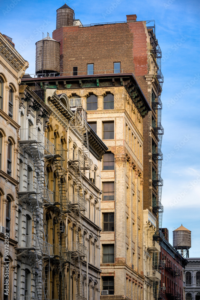 Cornices and fire escapes with wooden water towers of Soho loft buildings, Manhattan, New York City