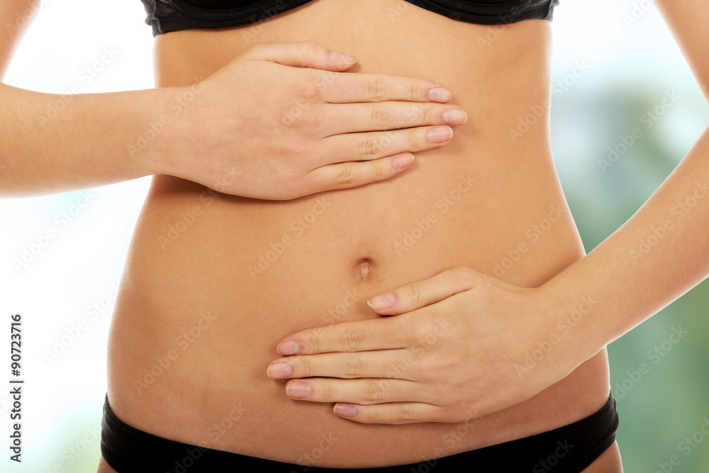 Woman touching her belly.