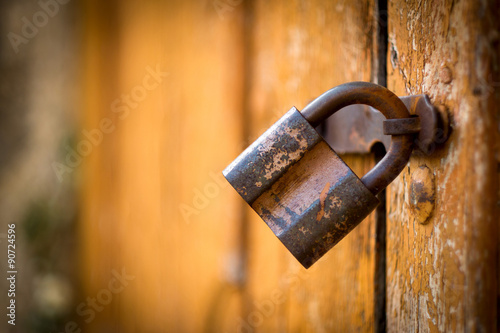 Old rusty lock on the vintage wooden door