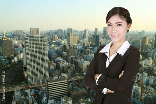 Business woman , crossed arms, with city