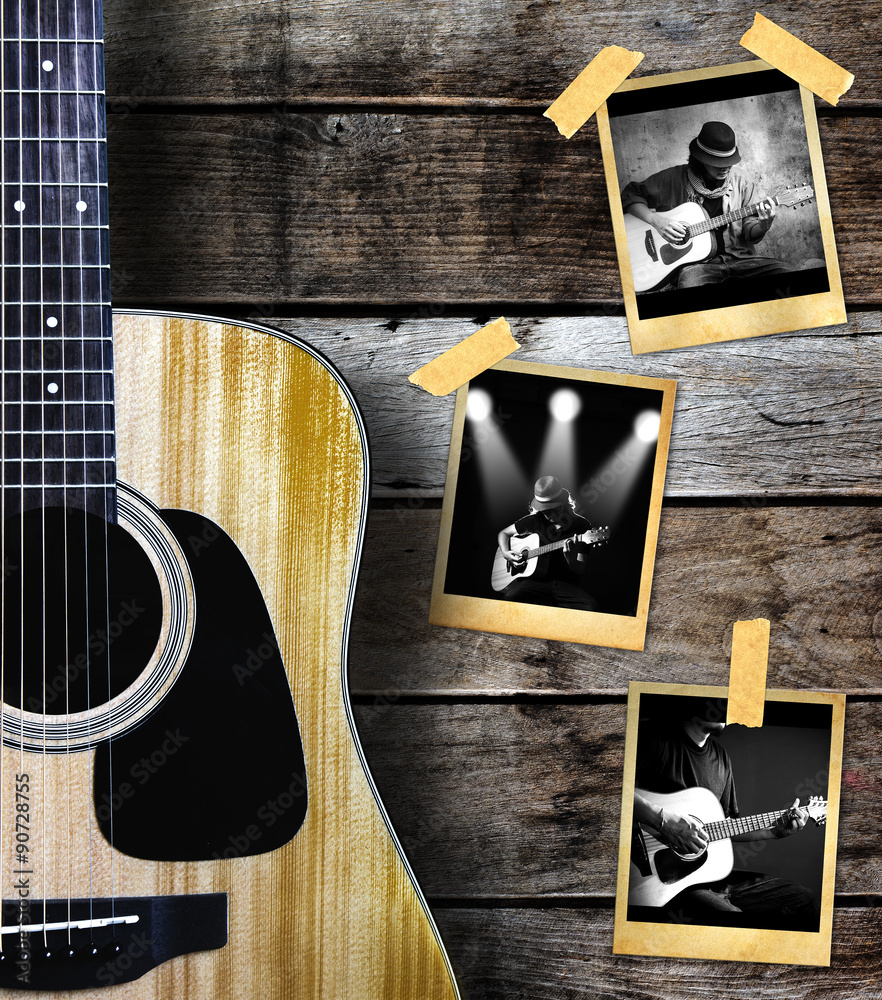 Fototapeta premium Guitar and guitarist photo photo frame on wood background.