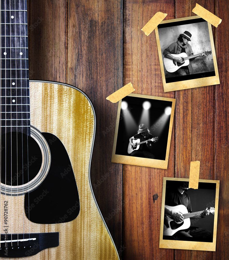 Fototapeta premium Guitar and guitarist photo photo frame on wood background.