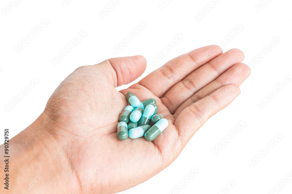 pill in male hand on white background isolated