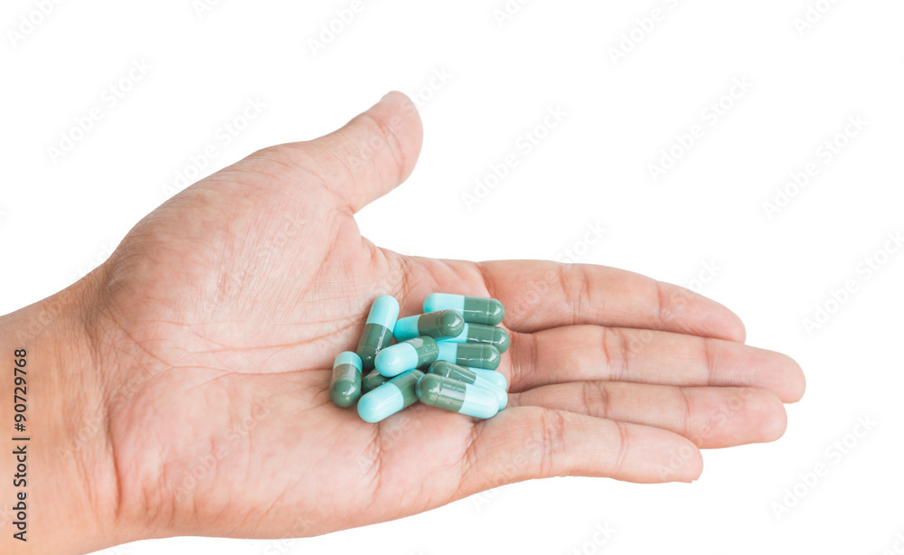 pill in male hand on white background isolated pill in male hand on white background isolated