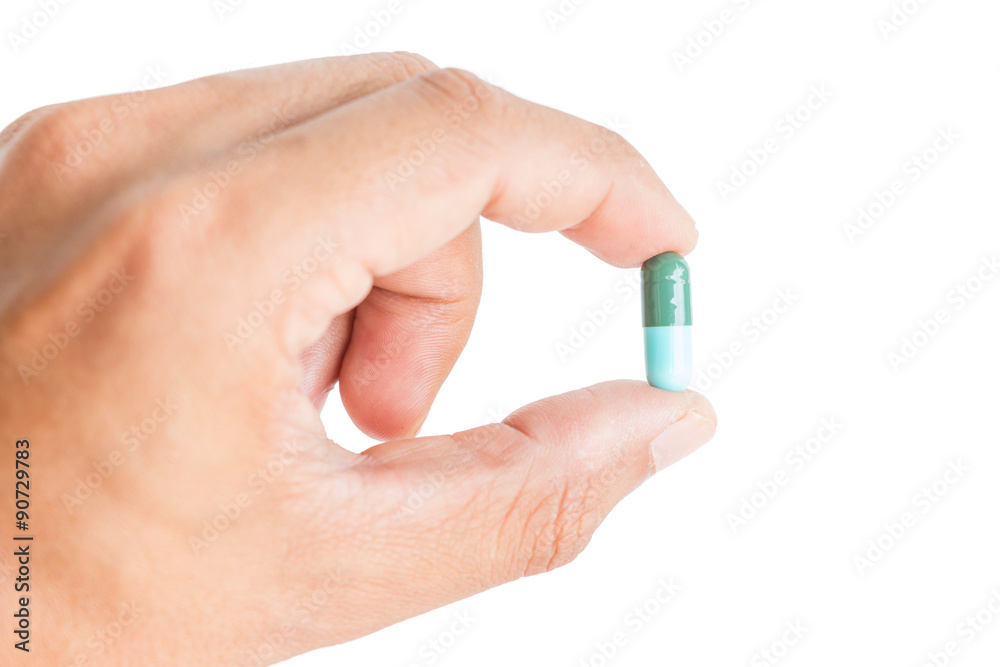 pill in male hand on white background isolated pill in male hand on white background isolated
