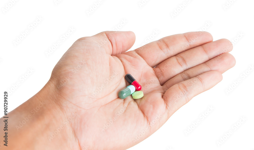 pill in male hand on white background isolated pill in male hand on white background isolated
