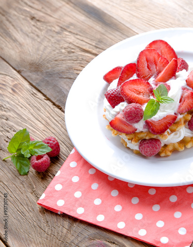 Belgian waffles with strawberries,raspberries and cream.