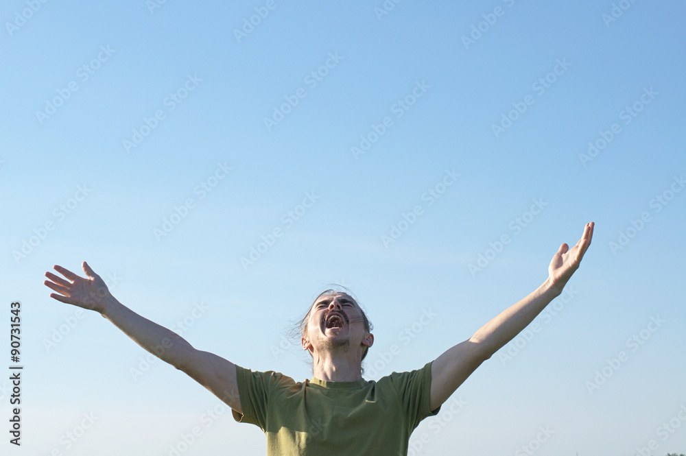 Young man screaming and appealing to the gods Young man screaming and appealing to the gods
