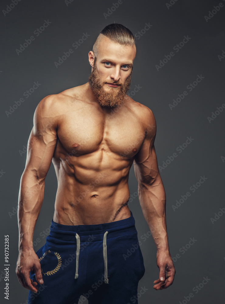 Shirtless bodybuilder with beard posing. Shirtless bodybuilder with beard posing.