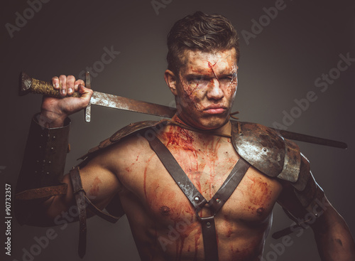 Bloody gladiator in armor.