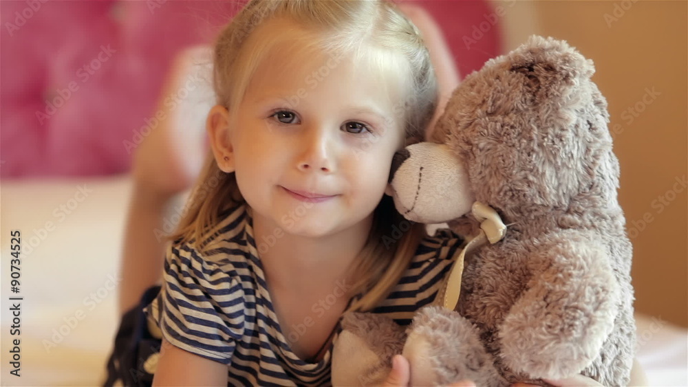 Adorable little girl hugging her bear Adorable little girl hugging her bear