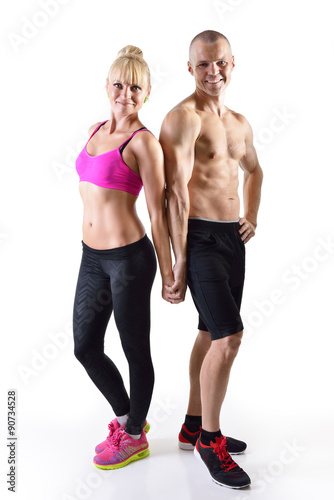 Athletic middle-age man and woman posing in studio.