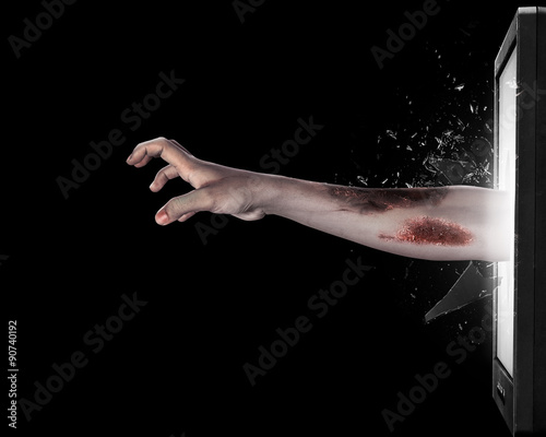 Zombie hand come out from television