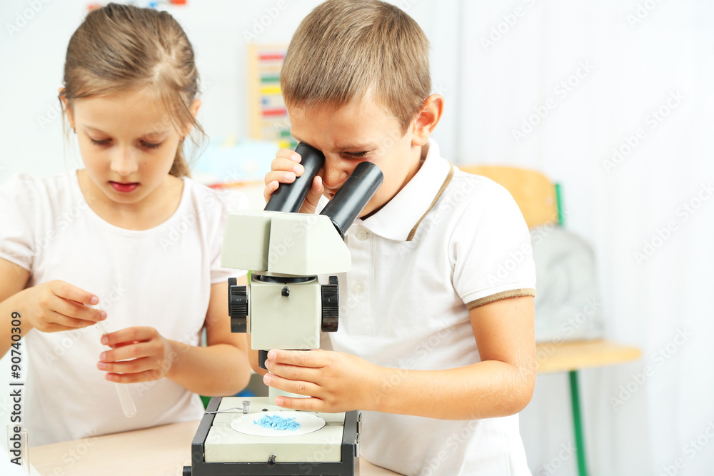 Cute pupils doing biochemistry research in chemistry class