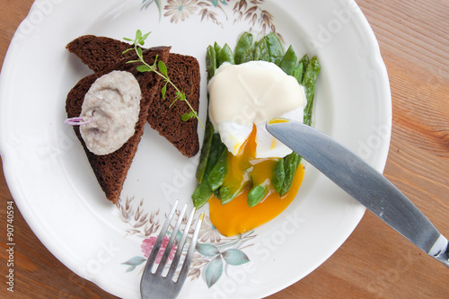 broken poached eggs on the greens photo