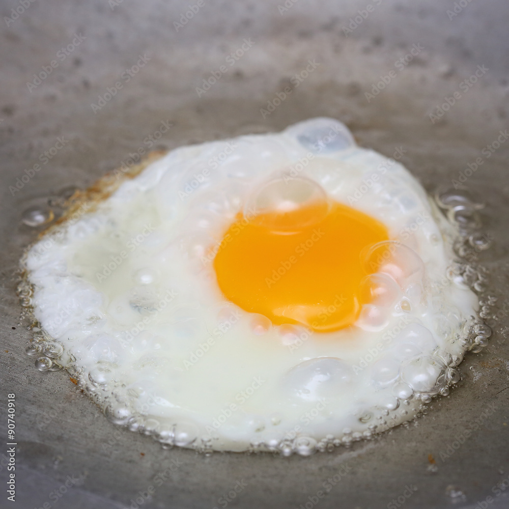 cooking fried egg in hot pan with oil cooking fried egg in hot pan with oil