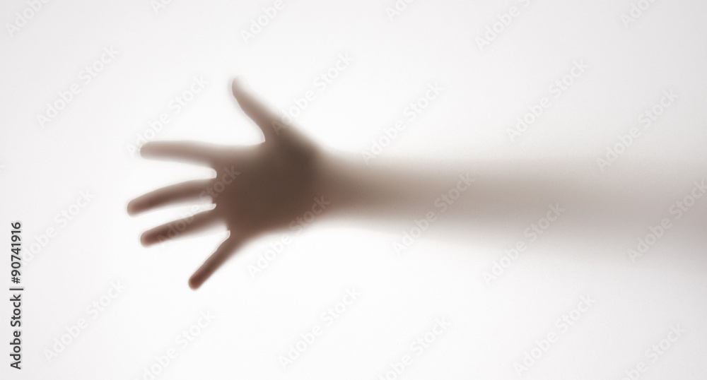 Fototapeta premium shadow of a hand behind transparent paper