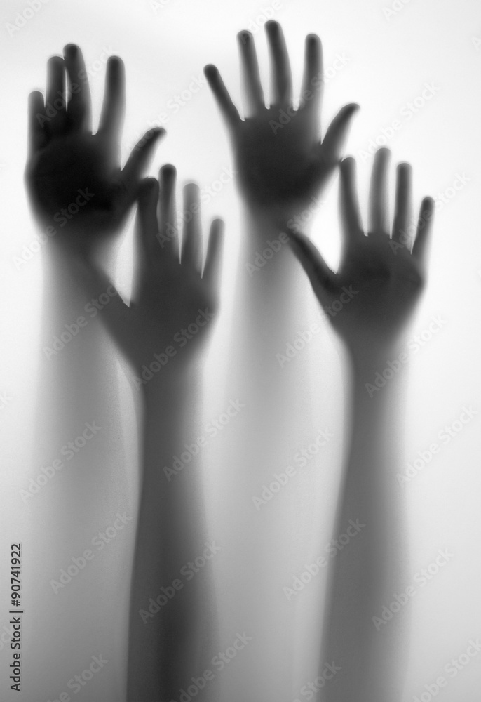 shadow of a hands behind transparent paper