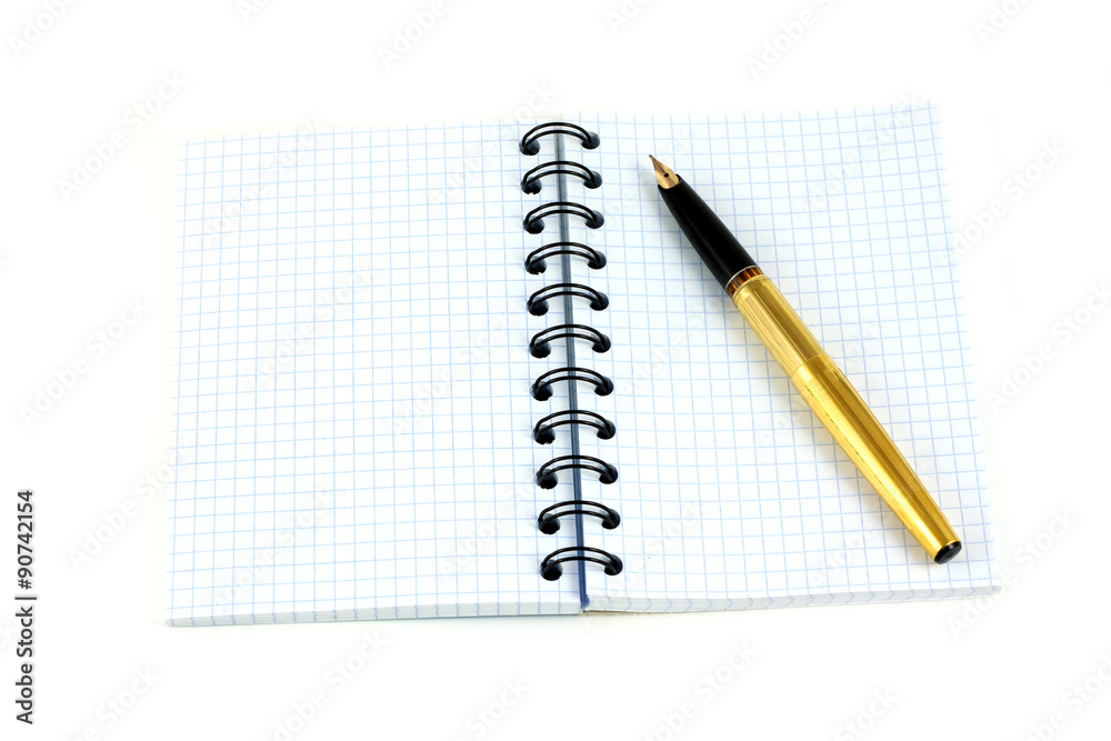 Spiral notebook and golden fountain pen isolated on white closeup Spiral notebook and golden fountain pen isolated on white closeup