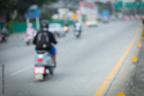 car and motorcycle driving on road with traffic jam in the city