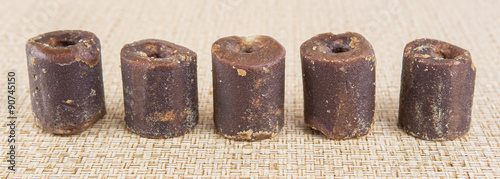 Coconut palm sap sugar or locally know as gula melaka over wicker background 