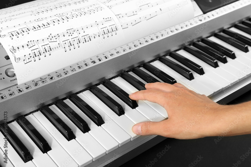 Fototapeta premium Woman playing synthesizer close up