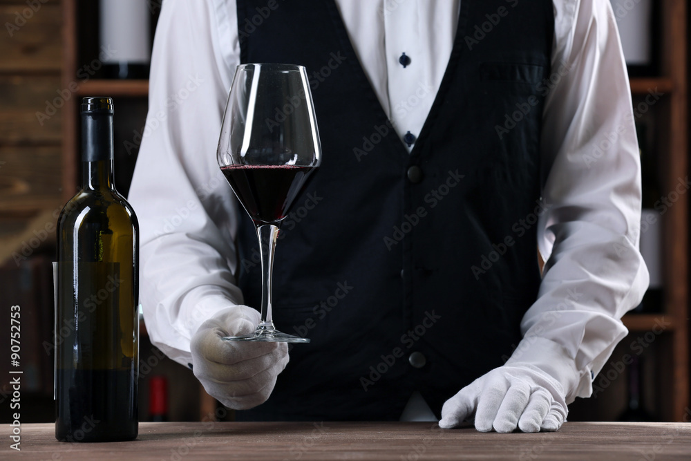 Bartender working at counter on bar background Bartender working at counter on bar background