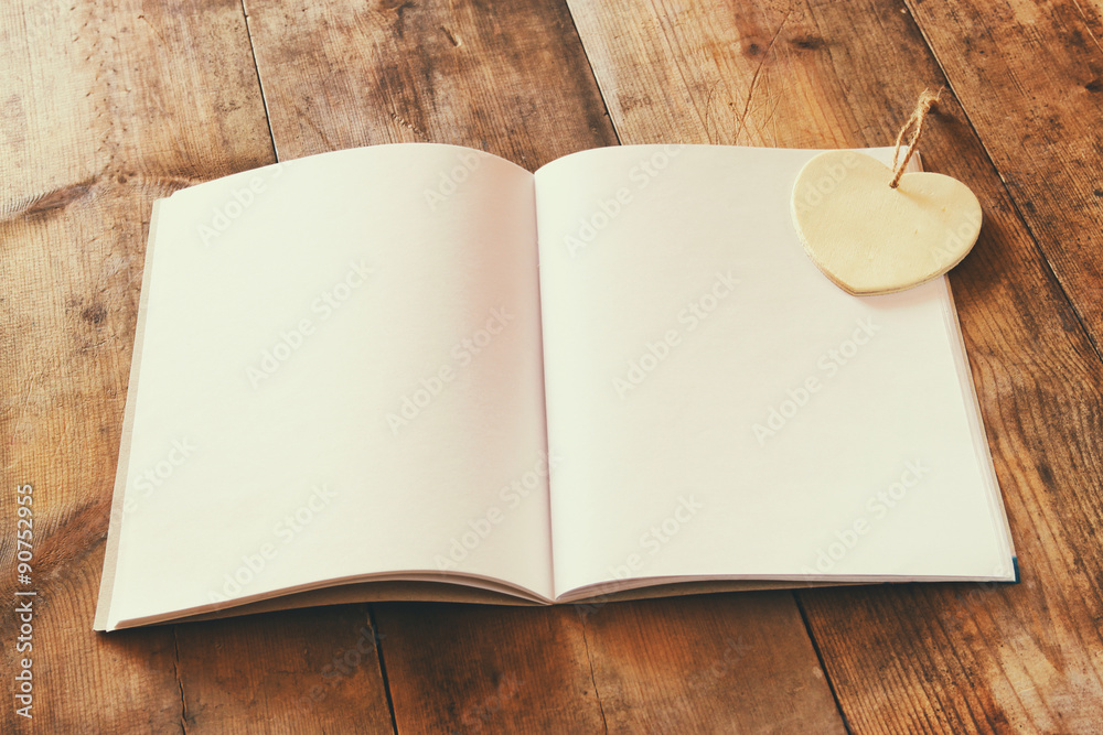 open blank notebook over wooden table. ready for mockup. retro filtered image
open blank notebook over wooden table. ready for mockup. retro filtered image