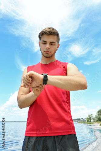 Runner looking at sports sm...