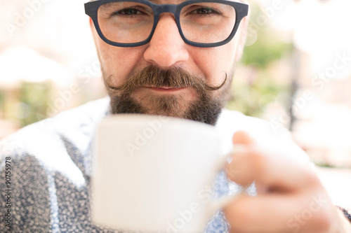 Close up of a man drinking coffee