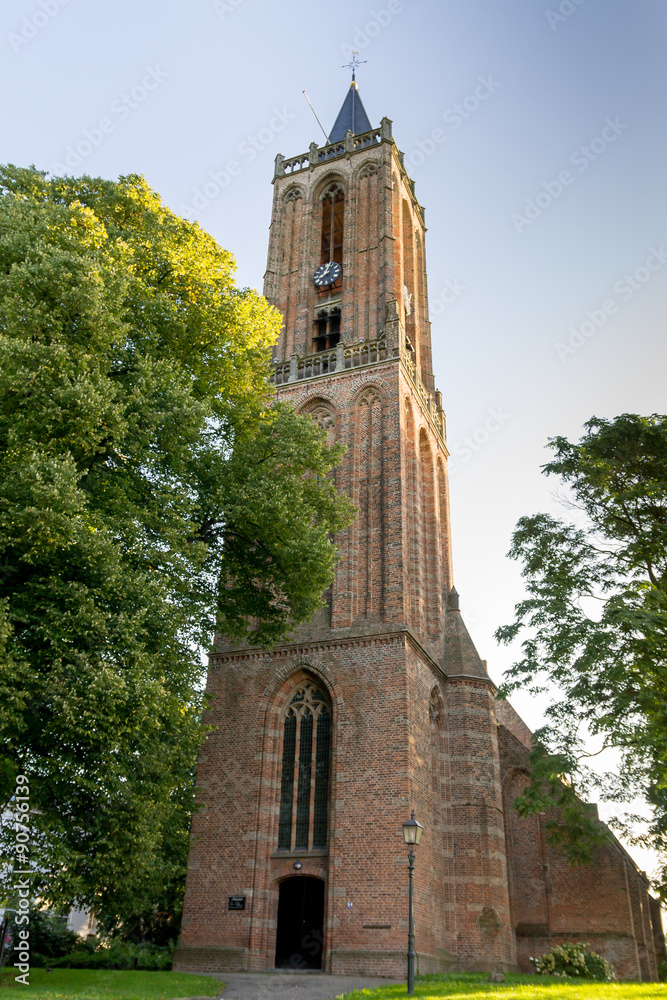 Church tower in Amerongen (Netherlands) against blue sky in summer.