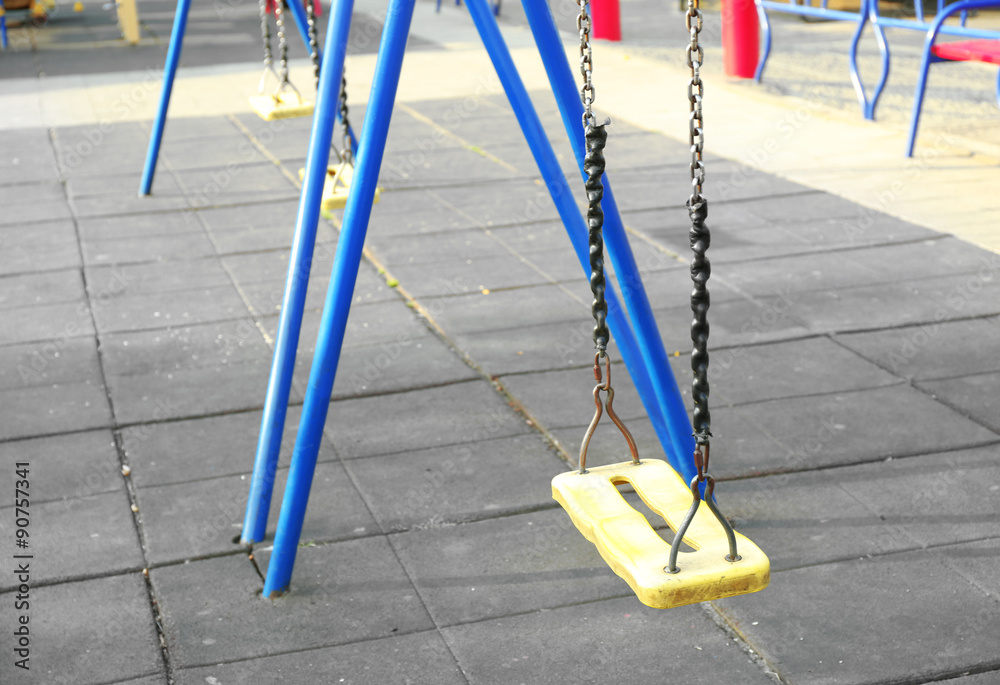 Empty seat of swings on children playground in park Empty seat of swings on children playground in park