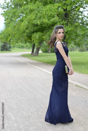 Obraz Beautiful formally dressed young woman standing outside in park