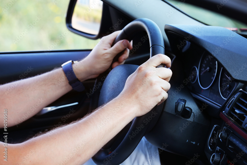 Male hand driving car