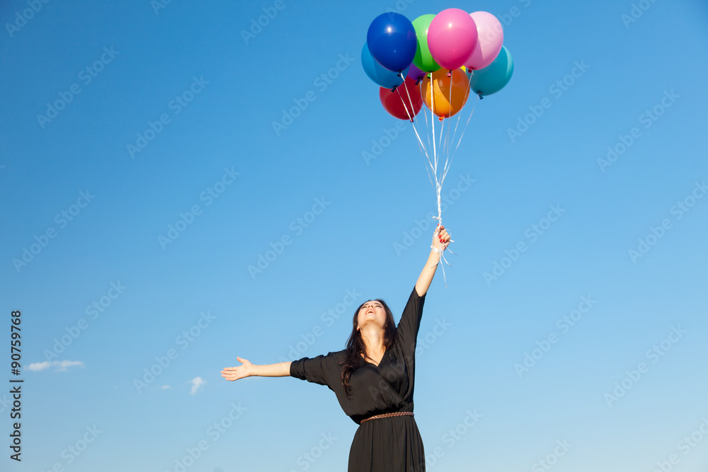 girl in black dress with multicolored balloons girl in black dress with multicolored balloons