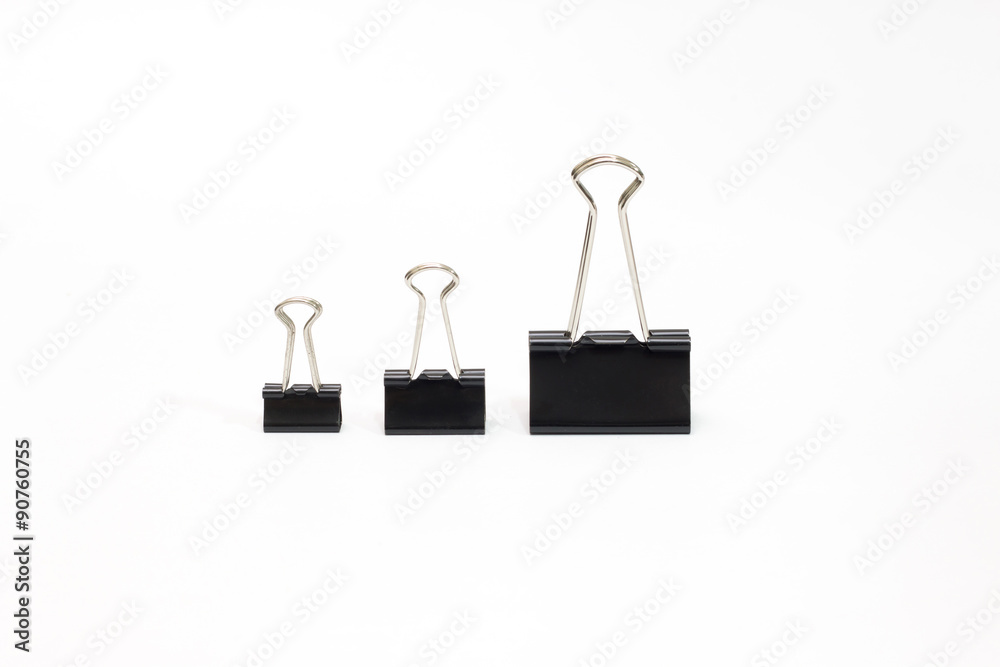 three office paper clips of different sizes on a white background three office paper clips of different sizes on a white background