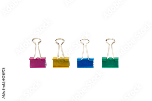 four office paper clips of different colors on a white background