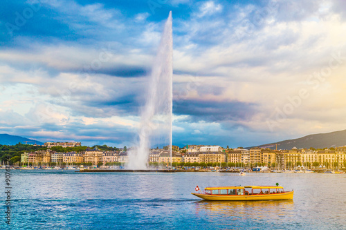 City of Geneva with famous Jet d'Eau fountain at sunset, Switzerland photo