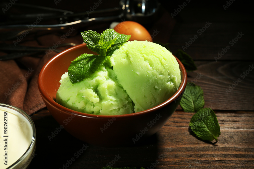 Homemade mint ice-cream on dark wooden background Homemade mint ice-cream on dark wooden background