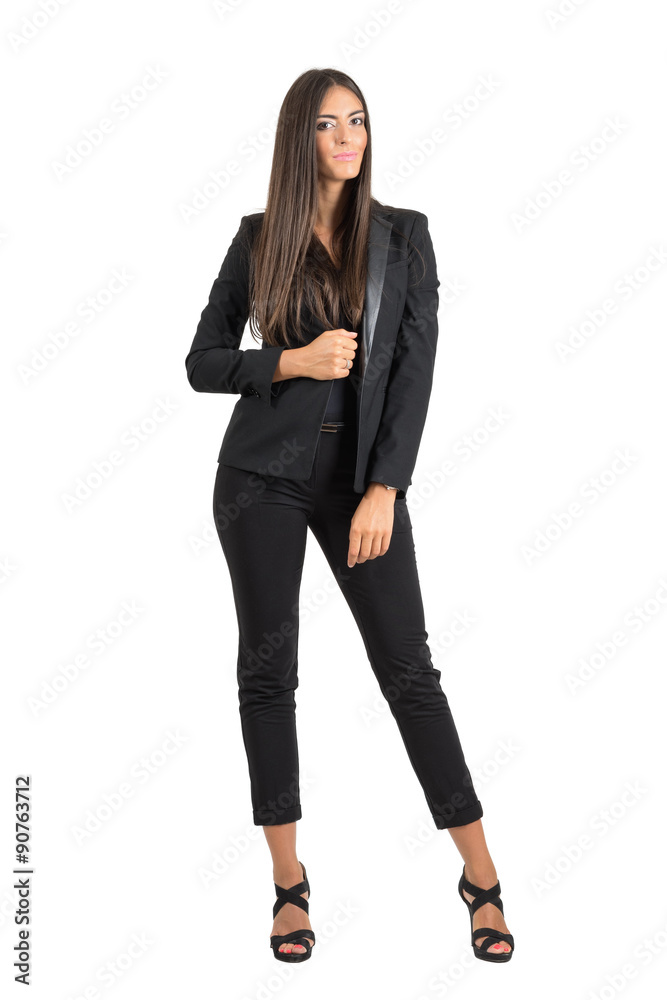 Pretty young tanned business woman posing and smiling while looking at camera Pretty young tanned business woman posing and smiling while looking at camera