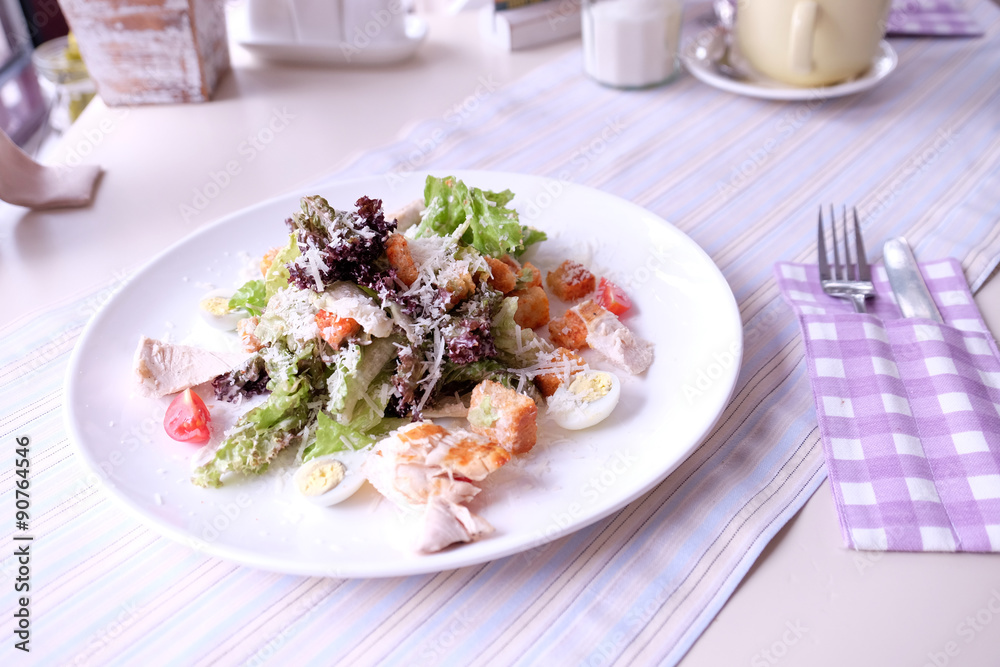 Caesar salad on table in cafe Caesar salad on table in cafe