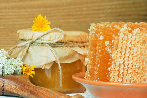 Flower honey in honeycombs and in a jar.