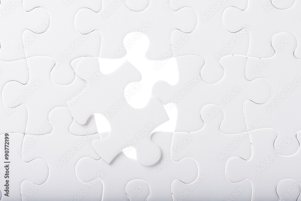 Missing jigsaw puzzle piece with light glow