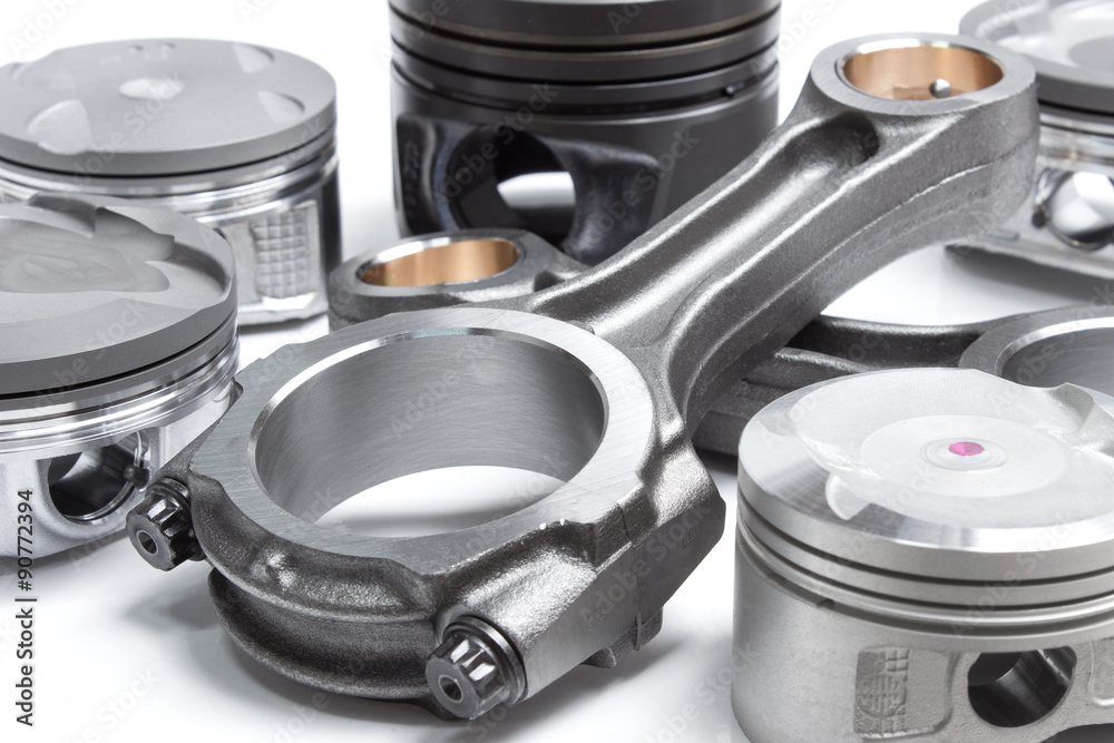 a set of pistons and rods for automobile engine on a white background a set of pistons and rods for automobile engine on a white background