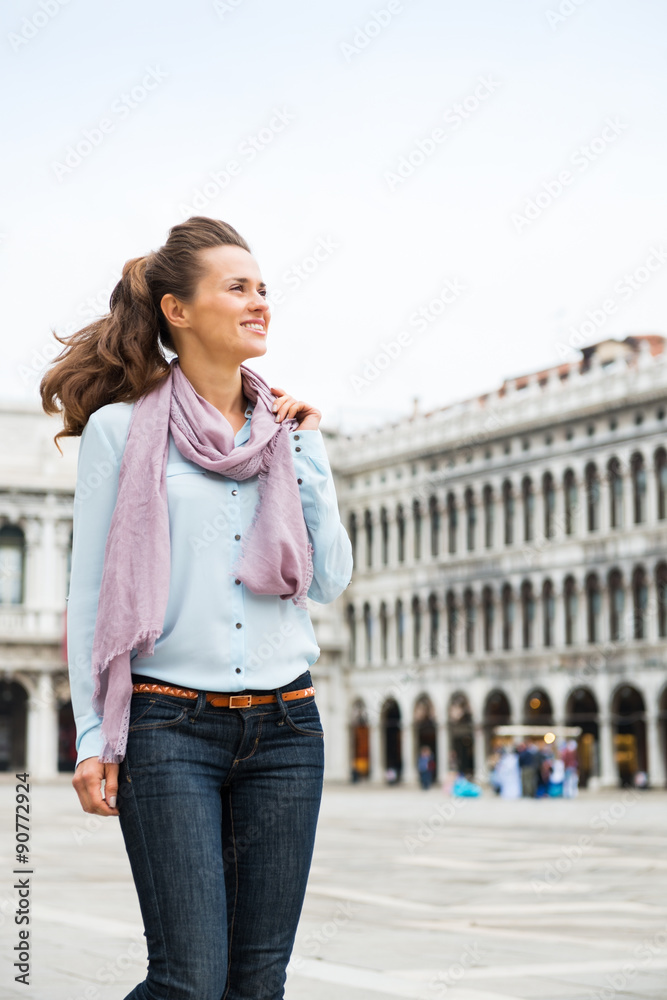 Happy woman tourist walking through St. Mark's Square