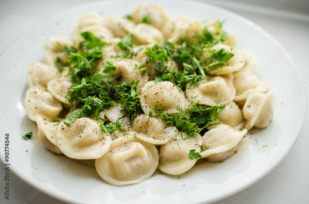 Boiled russian dumplings on the plate with parsley Boiled russian dumplings on the plate with parsley